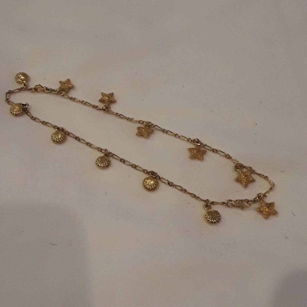 Gold tone ankle bracelet.